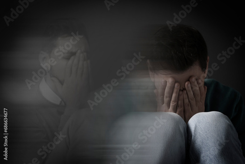 Man suffering from mental illness on dark background. Dissociative identity disorder photo