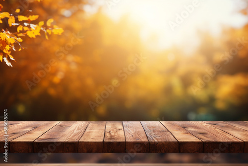 Empty wooden top table with blurred autumn background.