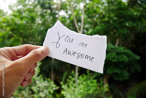 You Are Awesome text on a torn paper. Motivational inspirational quotes. © Ka Iki