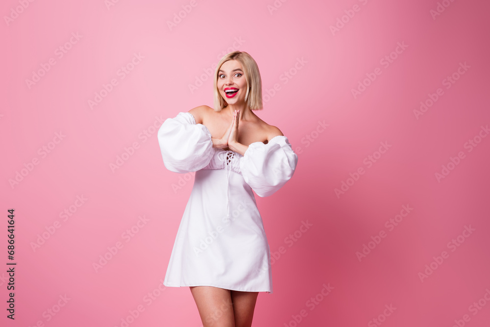 Photo of adorable excited lady wear off shoulders dress arms together exciting getting present empty space isolated pink color background Photo of adorable excited lady wear off shoulders dress arms together exciting getting present empty space isolated pink color background