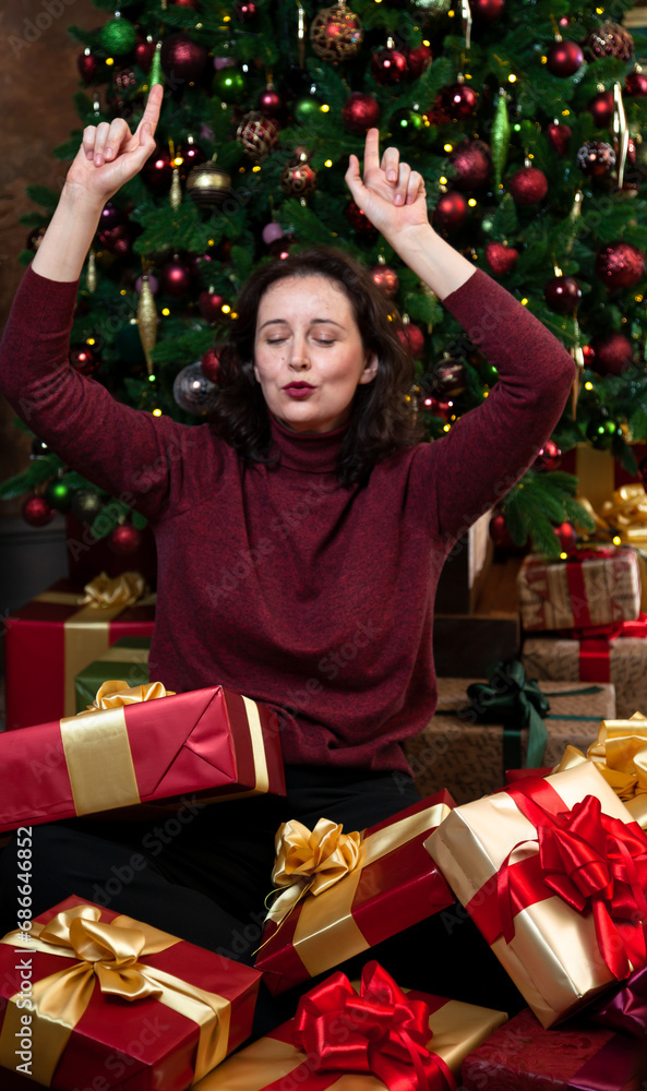 Joyful brunette woman overwhelmed with New Year gifts.... Joyful brunette woman overwhelmed with New Year gifts....