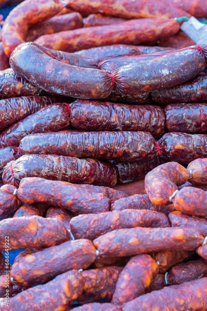 Fototapeta premium Chorizos and morcillas, typical products of the Spanish gastronomy homemade and for sale in a traditional street market.