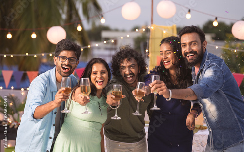 Konstfotografi Group of youthful Friends saying happy new year by holding champagne glassless d