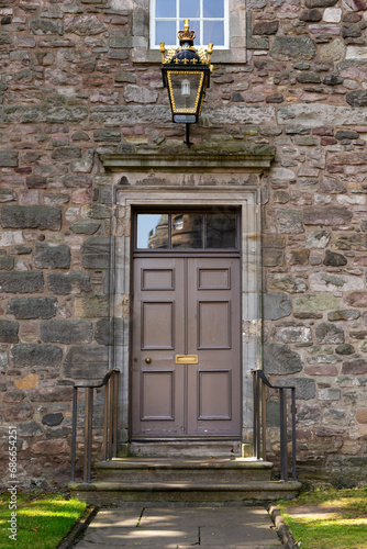 Old Georgian stone townhouse door with fanlight window above door