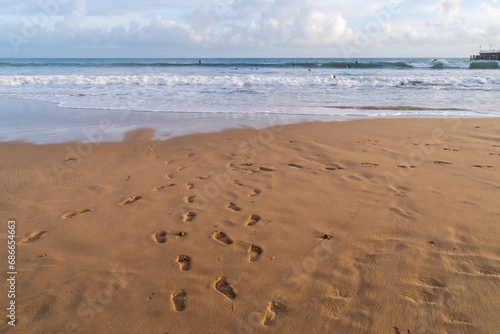 Footprints in the wet sand on Bournemouth East Beach, UK