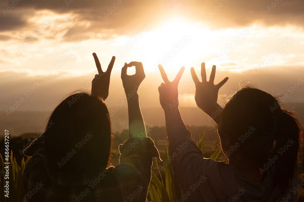Hands with New Year 2024 symbols, Hands with Happy New Year and beautiful sunrise or sunset background, background for New Year graphics. - obrazy, fototapety, plakaty 