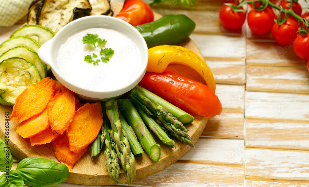 vegetables with yoghurt dip on wooden board