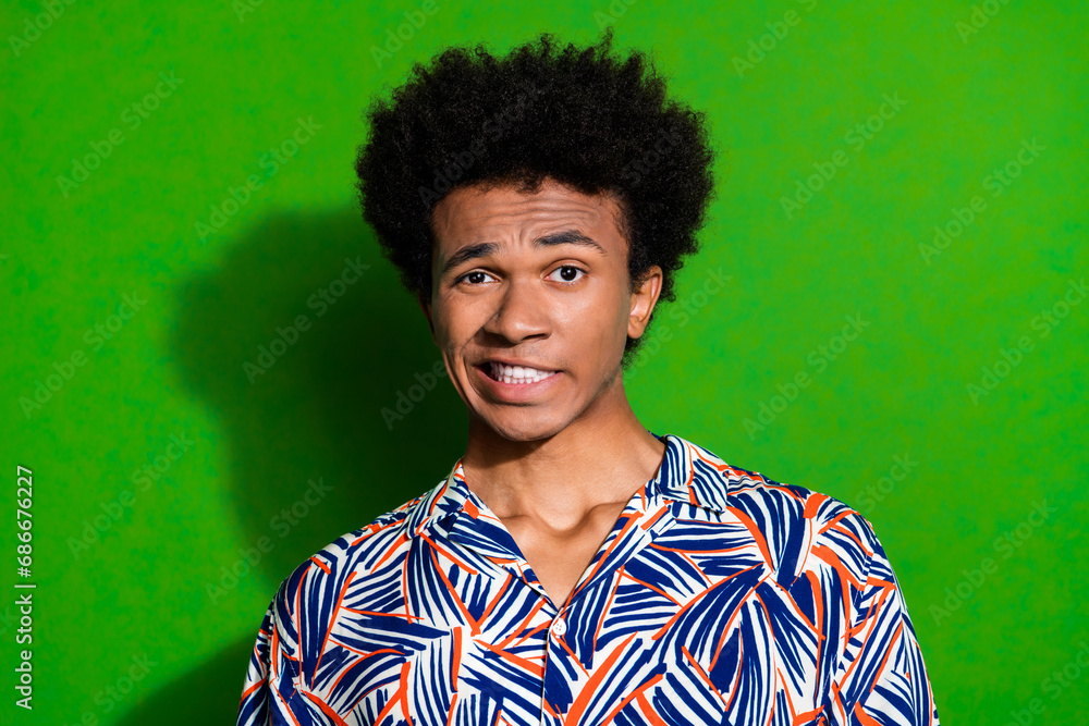 Oops sorry photo portrait of young guy negative reaction grimacing disgusting view destroyed car isolated on green color background Oops sorry photo portrait of young guy negative reaction grimacing disgusting view destroyed car isolated on green color background