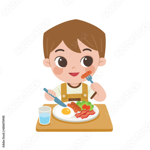 Kid having delicious food. Happy boy enjoy eating breakfast with fried eggs, bacon, sausages and fresh salad