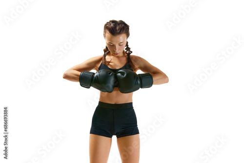 Dynamic and energetic  boxer girl  female professional sportsman in action against white studio background symbolizes power and determination.
