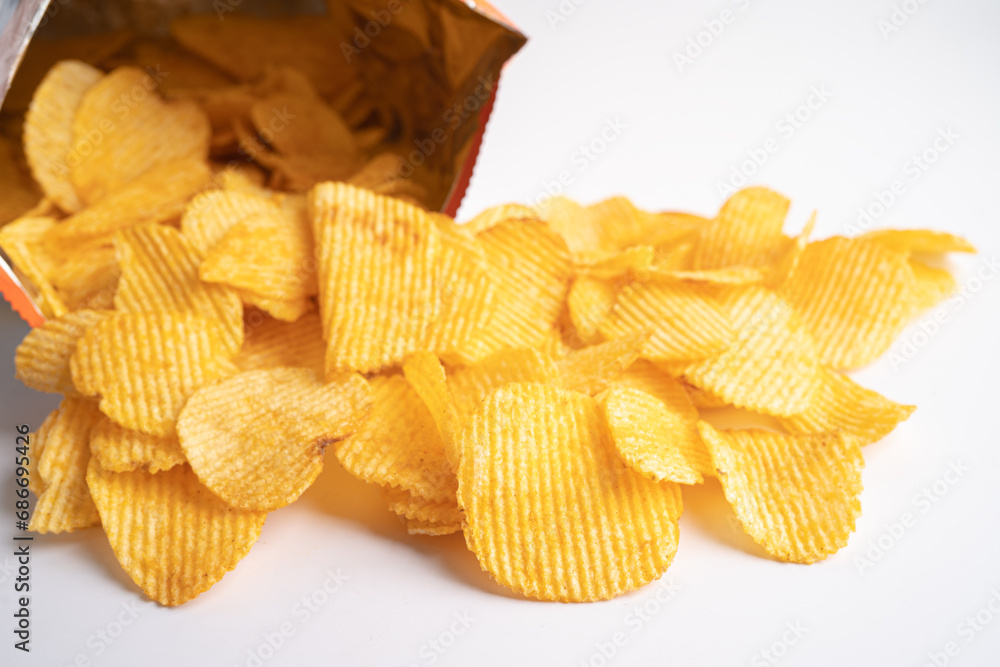 Potato chips, delicious BBQ seasoning spicy for crips, thin slice deep fried snack fast food in open bag. Potato chips, delicious BBQ seasoning spicy for crips, thin slice deep fried snack fast food in open bag.