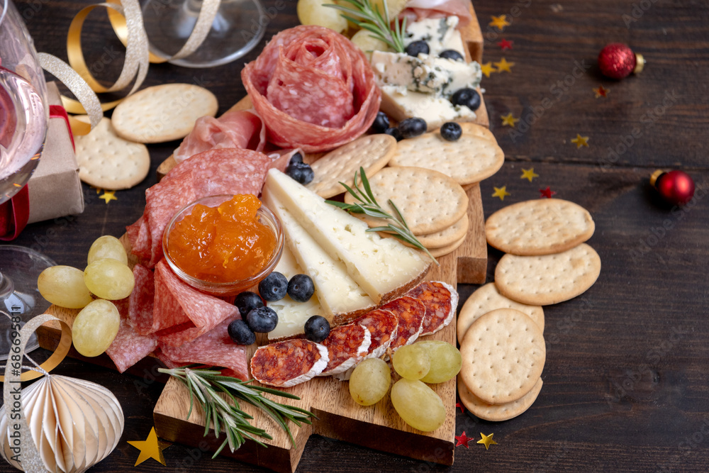 Party charcuterie board italian food antipasti prosciutto ham, salami and cheese appetizers served in the shape of a Christmas tree. party food for New Year's Eve, Christmas or birthday Party charcuterie board italian food antipasti prosciutto ham, salami and cheese appetizers served in the shape of a Christmas tree. party food for New Year's Eve, Christmas or birthday