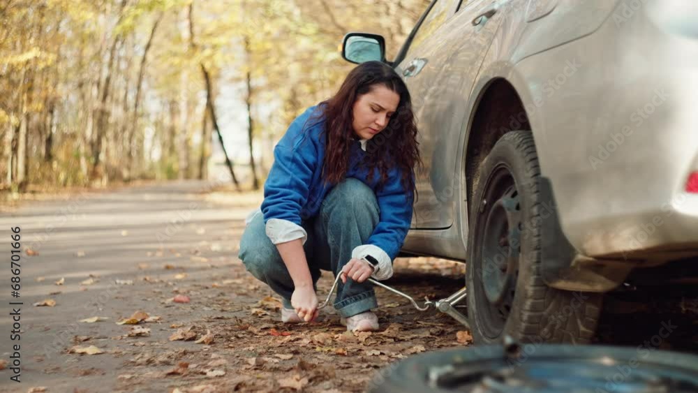 Roadside Resilience: Woman Changing Flat Tire During Journey, Roadside Breakdown. High quality 4k footage Roadside Resilience: Woman Changing Flat Tire During Journey, Roadside Breakdown. High quality 4k footage