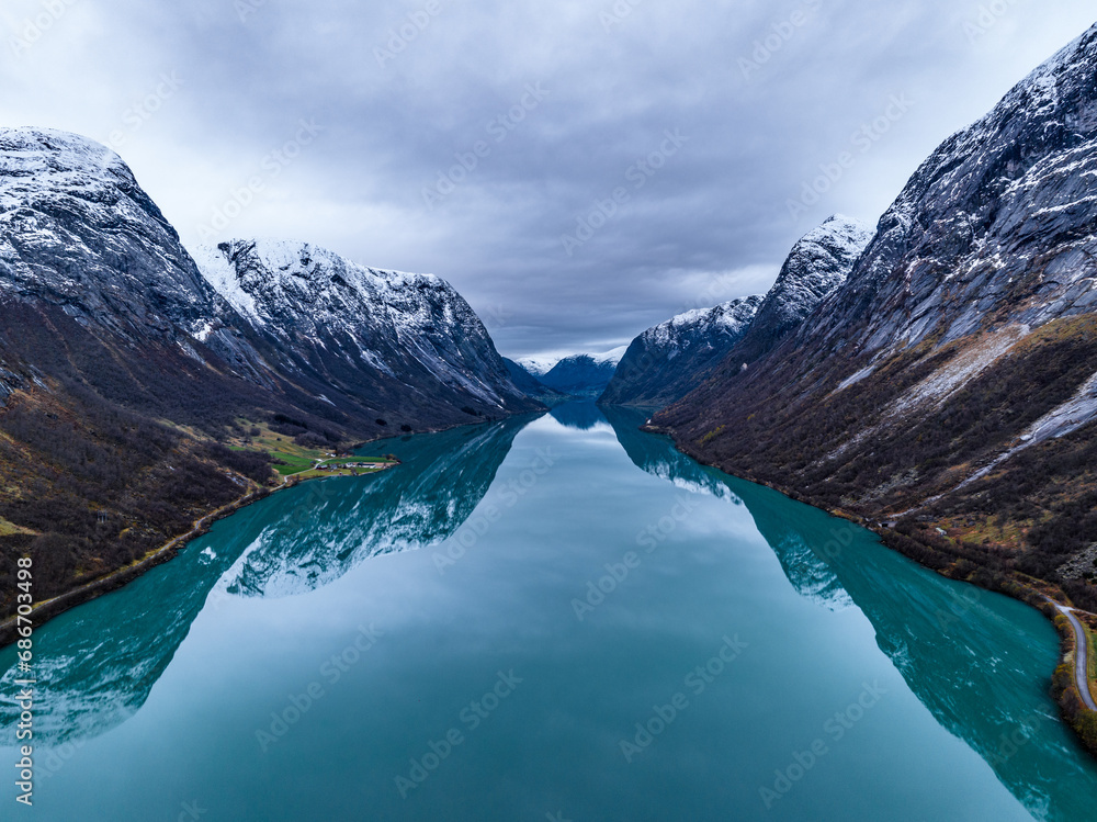 symmetrical erial view over blue mountain lake in norwegian mountains with reflections - obrazy, fototapety, plakaty 