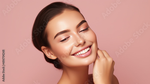 Portrait of young beautiful woman with perfect smooth skin isolated over pink background
