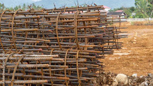 pile of Circular Reinforced Steel Columns for Reinforcing Wire for Pile Foundation Construction Photo Background. photo