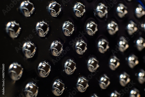 Zesters on a cheese grater with a dark background