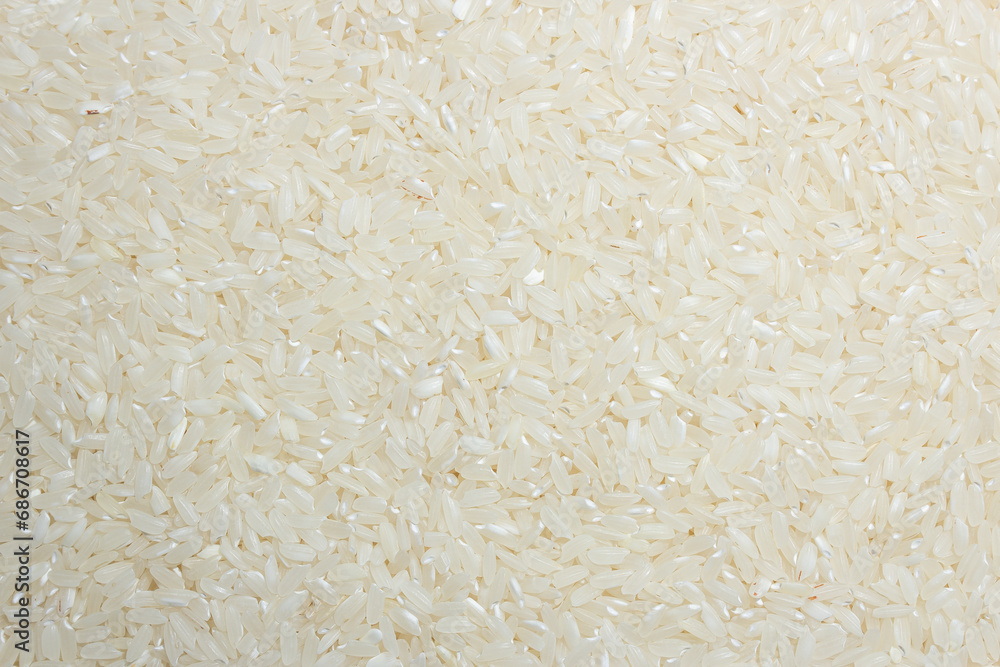 Dry Uncooked White Rice Background - Top View, Flat Lay. Scattered Raw Long Grain Rice. Asian Cuisine and Culture. Healthy Eating Ingredients. Diet Food Dry Uncooked White Rice Background - Top View, Flat Lay. Scattered Raw Long Grain Rice. Asian Cuisine and Culture. Healthy Eating Ingredients. Diet Food