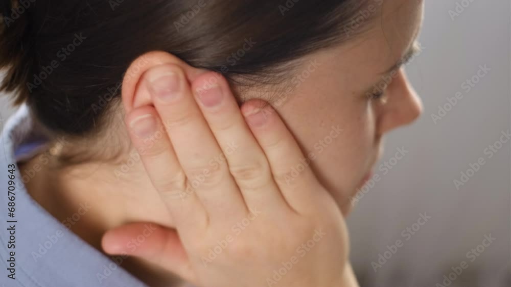 Close up of unhappy young female holding painful ear, suddenly feeling strong ache. Unhealthy tired caucasian woman 25s suffering from painful otitis sitting on couch at home. Health problems concept Close up of unhappy young female holding painful ear, suddenly feeling strong ache. Unhealthy tired caucasian woman 25s suffering from painful otitis sitting on couch at home. Health problems concept