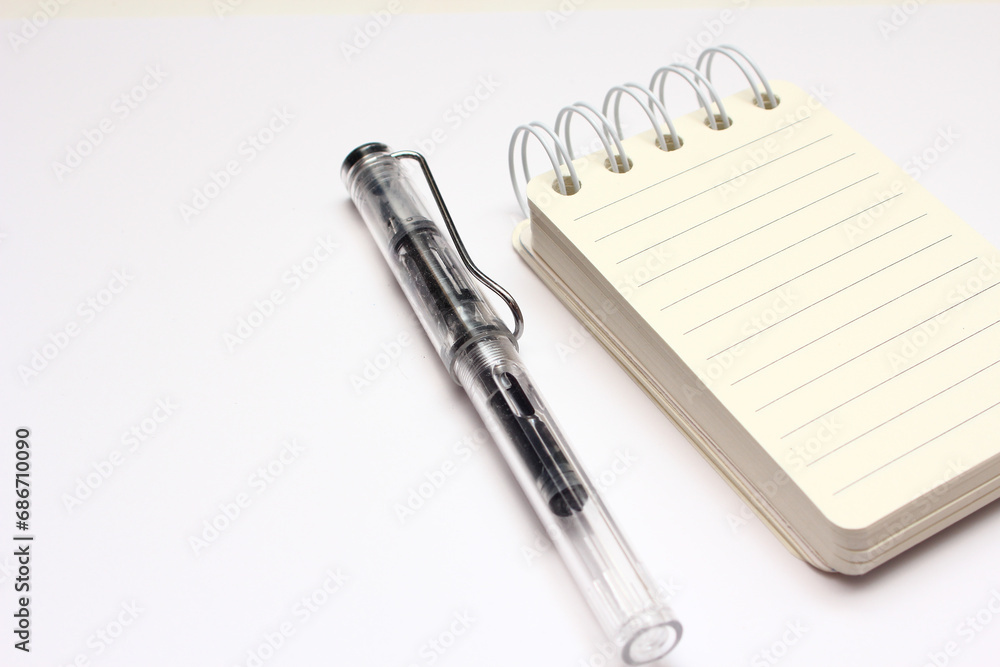 notebook and pen isolated on white background, closeup of photo notebook and pen isolated on white background, closeup of photo