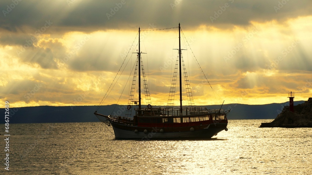 Big boat in beautiful sunset with rays of light