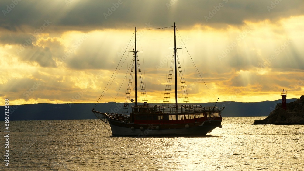 Big boat in beautiful sunset with rays of light Big boat in beautiful sunset with rays of light