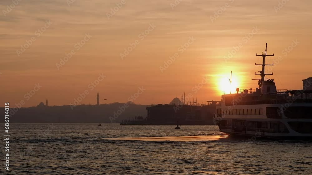 Sunset in Istanbul. Bosphorus with ferry boat. Sun behind silhouettes of minaret Sunset in Istanbul. Bosphorus with ferry boat. Sun behind silhouettes of minaret