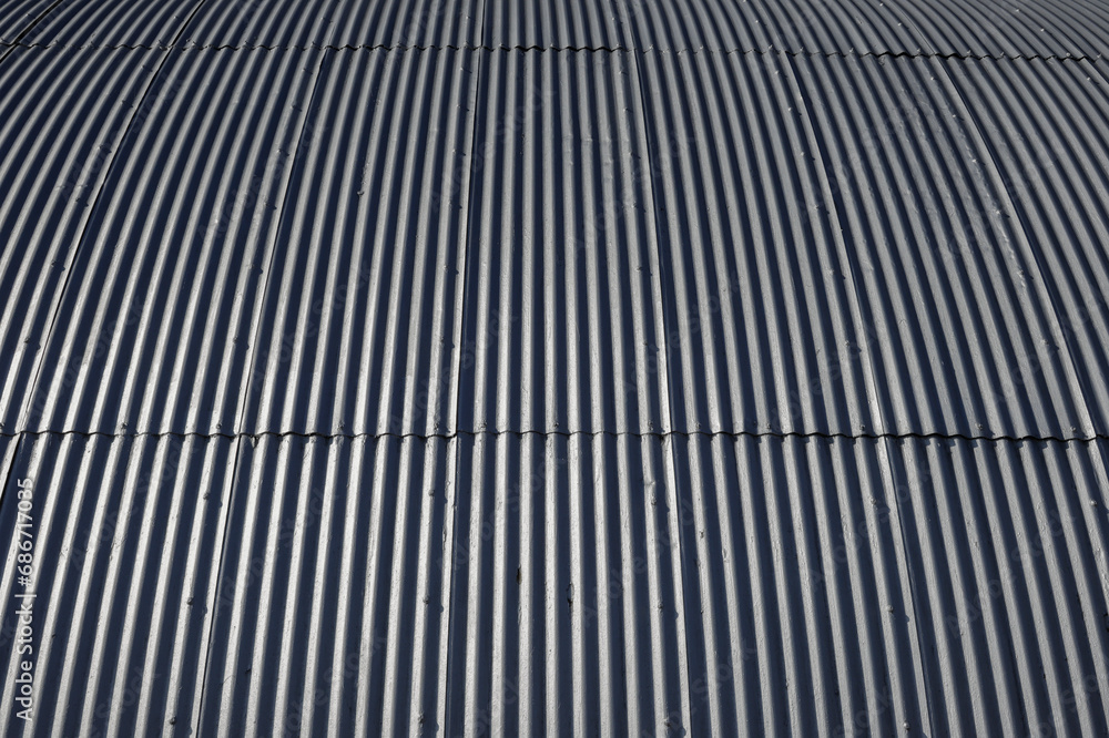 Corrugated galvanized steel panels on the exterior of a building. For background, wallpaper or clipping mask. Corrugated galvanized steel panels on the exterior of a building. For background, wallpaper or clipping mask.