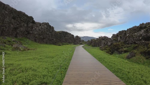 DOLLY SHOT - Almannagja is an eight-kilometer-long gorge within Pingvellir National Park, which marks the edge of the North American plate and the beginning of the Þingvellir rift valley in Iceland. photo