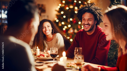 Happy diversity multi-ethnic friends having christmas dinner at home. Christmas tree on background