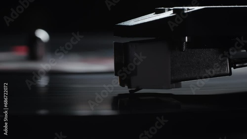 Retro Vinyl record player playing music, close-up macro shot of vintage LP disc old phonograph spinning. Retro music player at home. photo