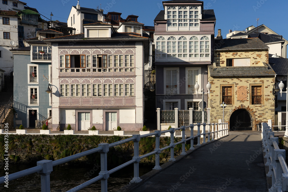 Kiss bridge in Luarca with typical house facades in a sunny day, Asturias, Spain.