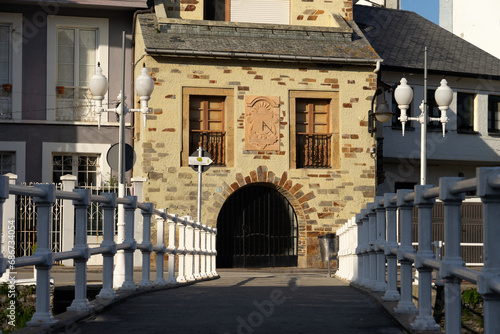 Kiss bridge in Luarca with typical house facades in a sunny day, Asturias, Spain. photo