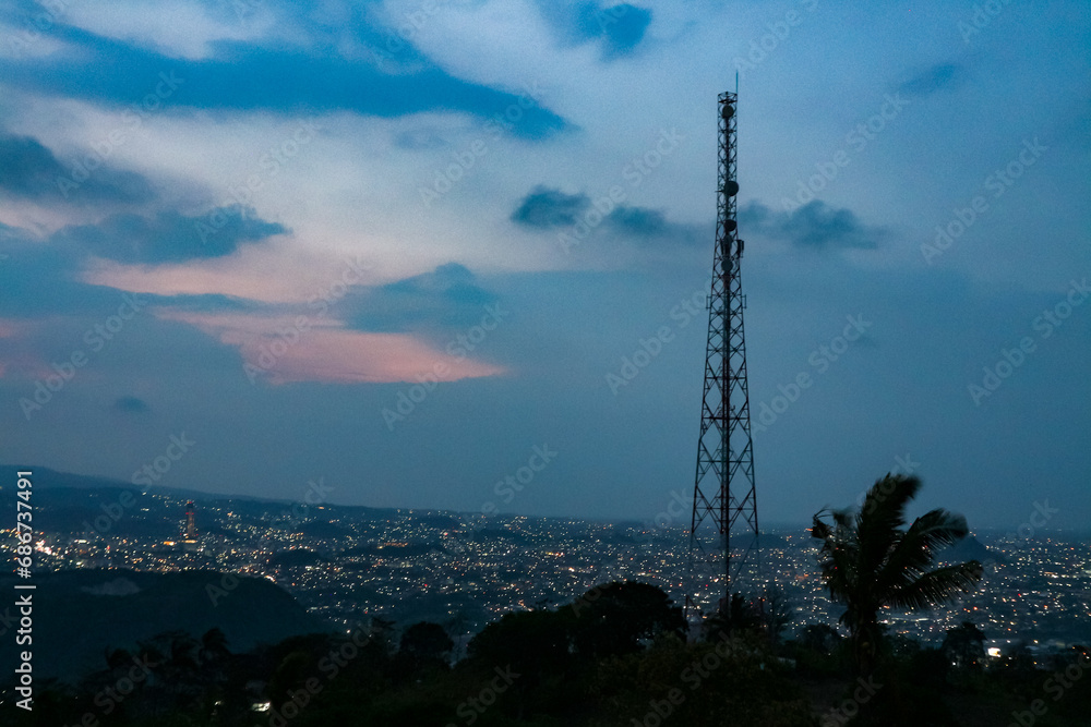 Telecommunication tower and cityscape at twilight, Telecommunication tower and cityscape at twilight,
