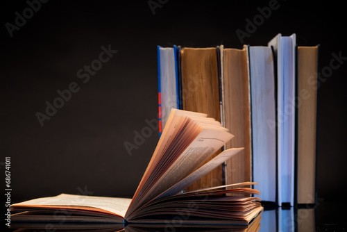 open book for reading and a stack of books