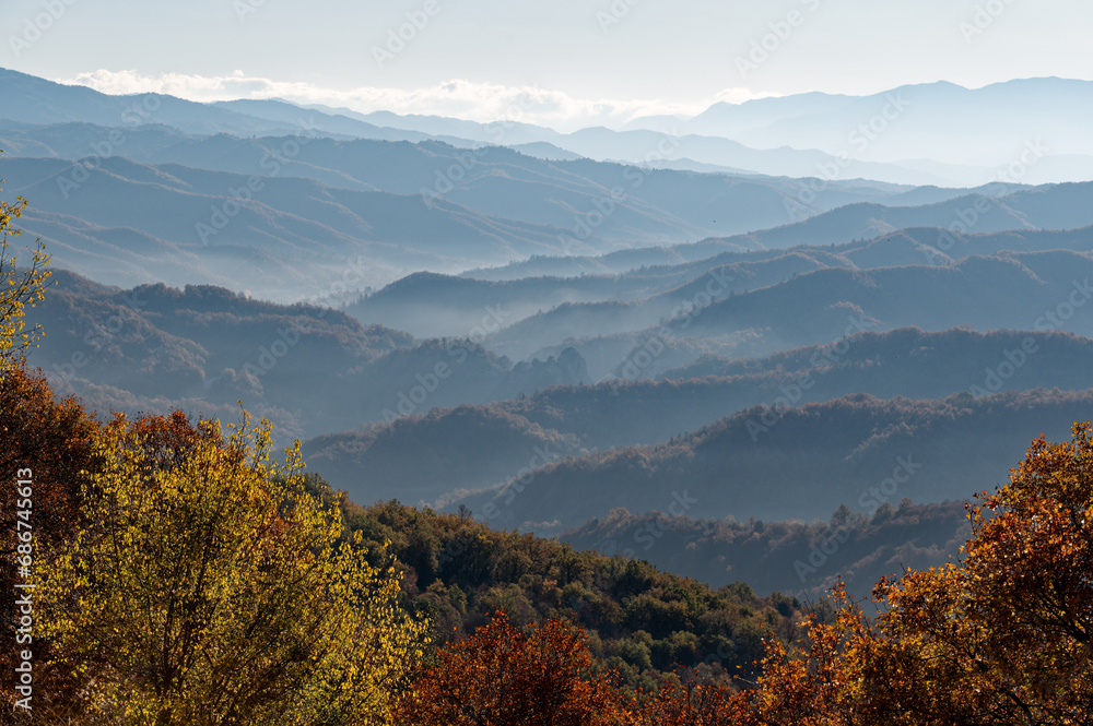 Panoramic mountain landscape of Zagori with morning mist and Autumn colours in Epirus, Greece
