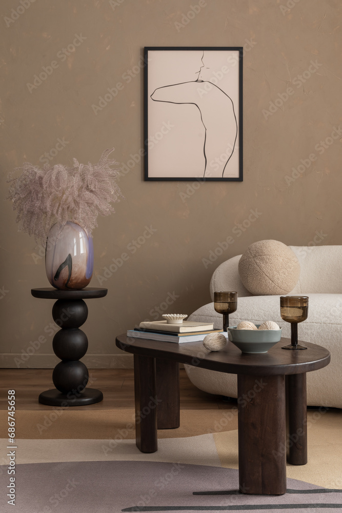 Obraz premium Aesthetic composition of living room interior with mock up poster frame, wooden coffee table, round stand, vase with dried flowers, boucle sofa, glass and personal accessories. Home decor. Template.