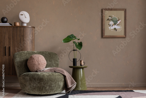 Interior design of stylish living room with mock up poster frame, copy space, green armchair, round coffee table, wooden sideboard, brown plaid, pillow and personal accessories. Home decor. Template. photo