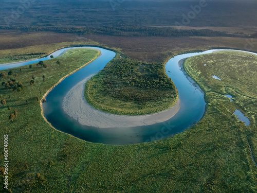 Aerial view of a river bend in Mount Aspiring National Park at sunrise; Haast, South Island, New Zealand photo