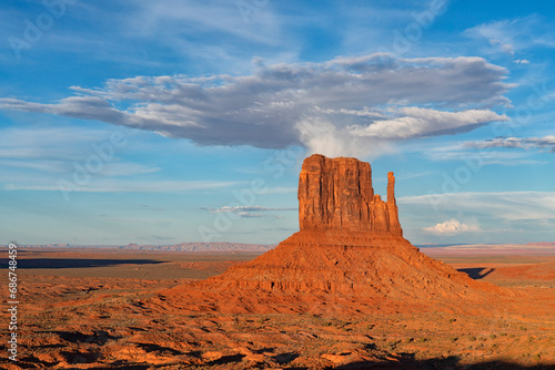 Rock formation called West Mitten butte in Monument Valley, Arizona.  The red rock glows at sunset as the light hits them; Arizona, United States of America