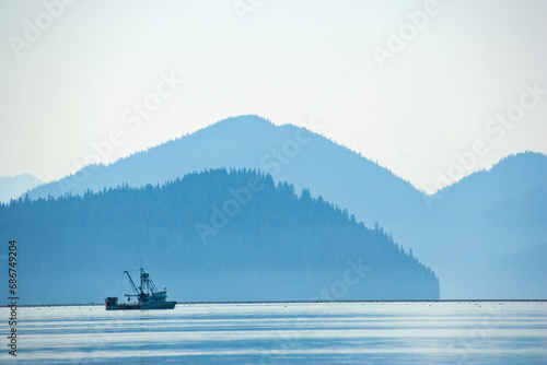 Fishing boat leaves the port of Petersburg; Petersburg, Mitkof Island, Alaska, United States of America photo