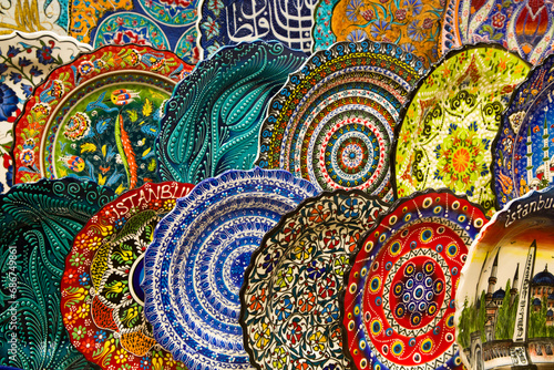 Dishware for sale, colorful plates in rows displayed in a shop in the Spice Bazaar in the Fatih District; Istanbul, Turkey photo