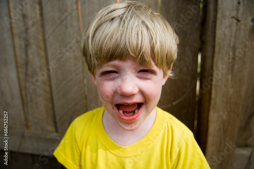 Young boy cries in his backyard; Dunbar, Nebraska, United States of America photo