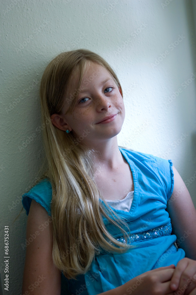 Portrait of a young girl sitting in natural light; Lincoln, Nebraska, United States of America Portrait of a young girl sitting in natural light; Lincoln, Nebraska, United States of America
