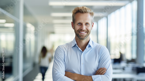 Smiling businessman standing in his office