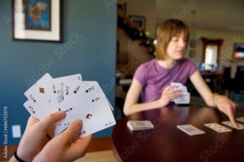 Girl plays Solitaire card game at home; Lincoln, Nebraska, United States of America photo
