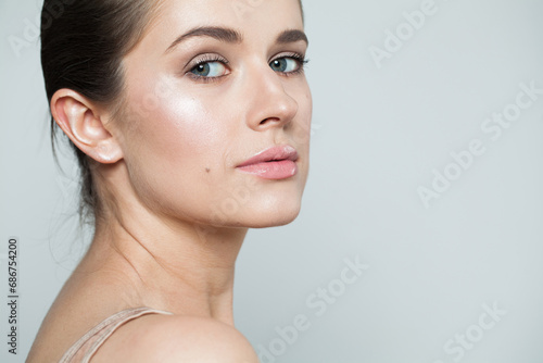 Brunette woman close up portrait. Beautiful spa model with perfect fresh clean skin. Youth and skin care concept. Nude makeup
