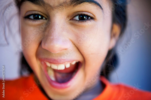 Close-up portrait of a young girl with an enthusiastic expression; Scottsdale, Arizona. photo