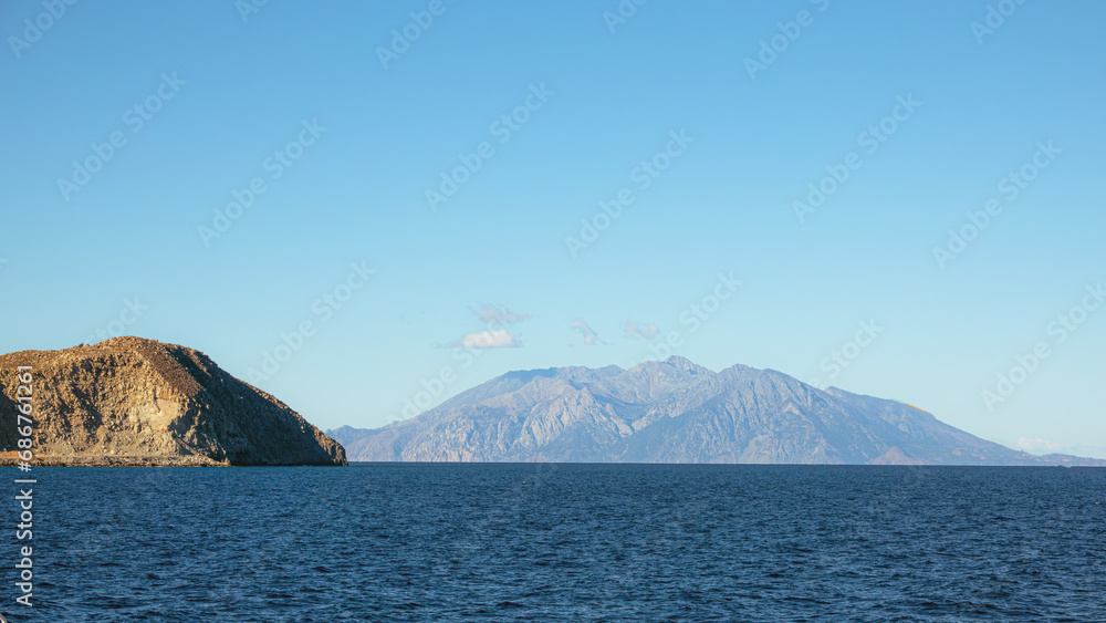 View of the Greek island Samothrace from the ship deck in Gokçeada Island, Turkey.The small rocky mountain on the left belongs to Gokceada. In this frame, two islands appear side by side.