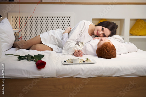 Young couple having romantic meal in bed